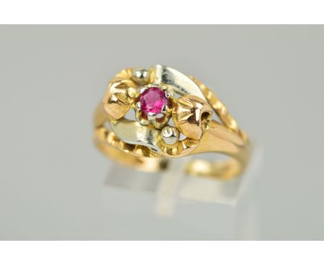 A RUBY DRESS RING, the central circular ruby within a claw setting, to the layered, vari-shaped, tri-colour surround, stamped