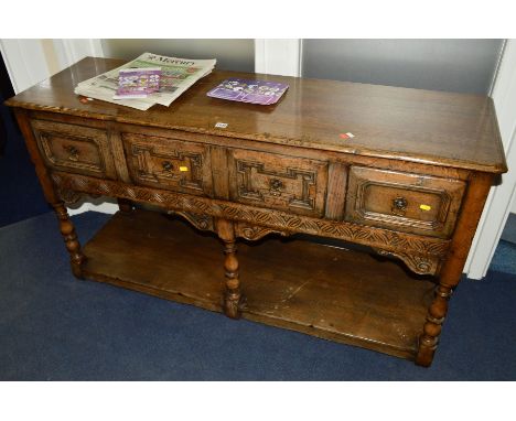 A TITCHMARSH AND GOODWIN OAK DRESSER BASE, the four drawers with geometric front, central rail with carved lunette detail and