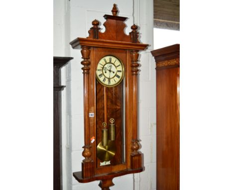 A VICTORIAN WALNUT VIENNA EIGHT DAY WALL CLOCK, the enamel dial with Roman numerals and seconds dial (winding key, two weight