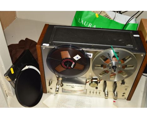AN AKAI GX4000 DB REEL TO REEL TAPE RECORDER, with a bag of tapes, runs and plays but slow to start we haven't tested the rec