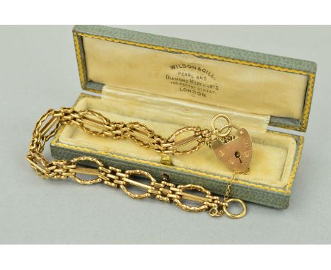 A 9CT GOLD BRACELET of a gate bracelet style design to the heart padlock clasp, with safety chain, with 9ct hallmark for Lond