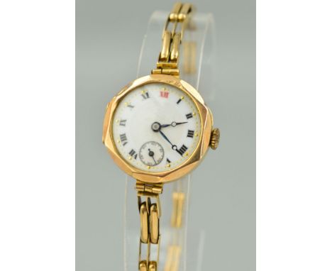 AN EARLY 20TH CENTURY 9CT GOLD LADY'S WRISTWATCH, white enamel dial with Roman numerals and seconds sweep subsidiary dial at 