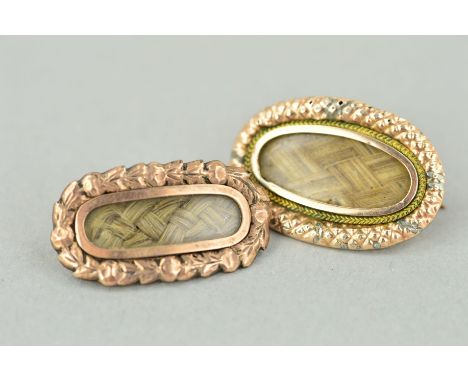 TWO MID VICTORIAN MEMORIAL BROOCHES, both of elongated outline with central glazed woven hair panel, the first within a folia