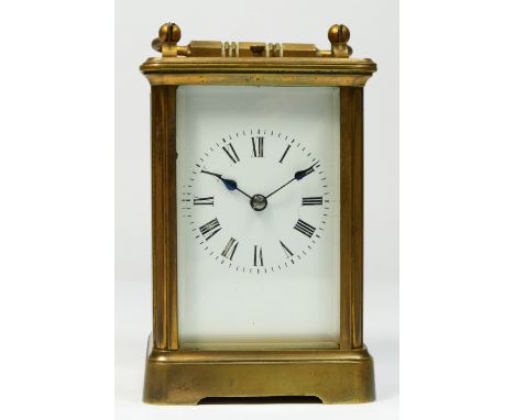 A brass repeating and striking carriage clock, white enamel dial with Roman numerals, the numbered movement striking on a gon