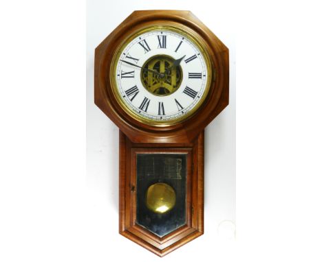 Ansonia Clock Co., New York, an early 20th century oak cased wall clock, the 12" dial with visible movement, pendulum, key, 8