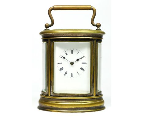 An early 20th century brass (showing traces of silver plate) oval striking carriage clock, white enamel dial with Roman numer