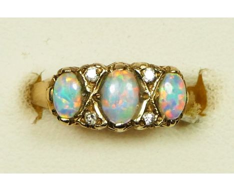 An Edwardian style 9ct gold three stone opal ring, diamond points between, K, 2.1gm. 