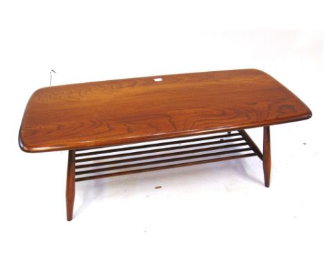 AN ERCOL COFFEE TABLE  of oblong form with magazine rack beneath, 104cm long 47cm deep 37cm high