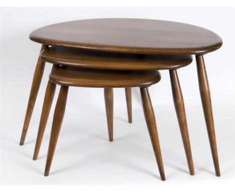 AN ERCOL NEST OF THREE 'PEBBLE' COFFEE TABLES,  labelled to base of largest table, the largest 65cm wide