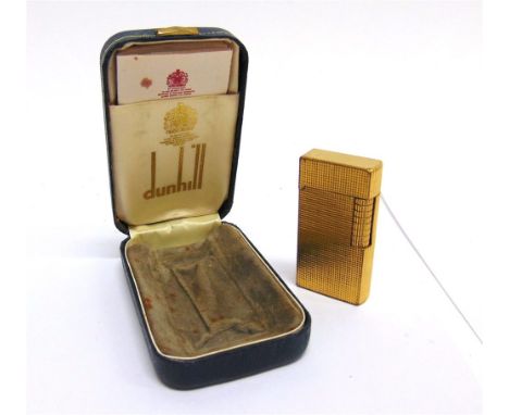 A DUNHILL GILT METAL CIGARETTE LIGHTER cased.