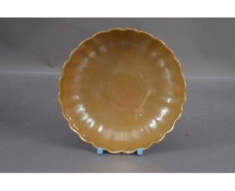 A Chinese Qing Dynasty café-au-lait monochrome glaze saucer dish, scalloped edge and fluted shape. Underglaze blue mark withi