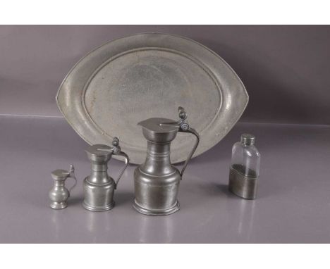 Three graduated lidded jugs in pewter with acorn thumpieces,  a planished pewter tray maked "Hampden Pewter" and a pewter mou