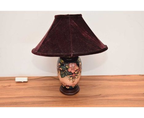 A modern Moorcroft Pottery lamp, with red velvet shde, total height 40cm