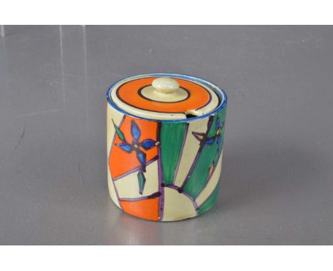 (ar) A Clarice Cliff 'Fantasque' for Wilkinson Ltd pottery jam or preserve pot with lid, orange, green and cream with blue ou