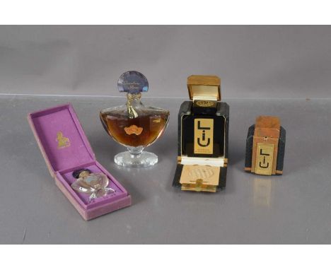 Four Guerlain perfume bottles, two contained in Art Deco boxes, three with contents.