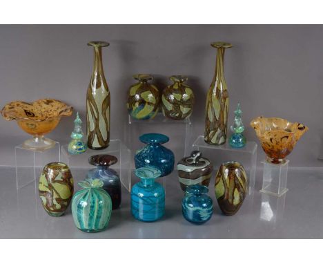 A collection sixteen of Mdina art glass items, including a pair of tall bottle vases in 'Earthtone' hues, a similar pair of s