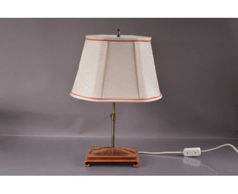 An adjustable brass table lamp with an oriental hardwood stand, fitted with a cream silk shade. The stand carved to fit a har