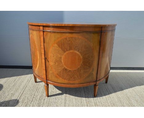A mid-20th Century demi lune mahigany and satinwood marquetry commode cabinet, with central hinged door. 124 cm wide by 51 cm