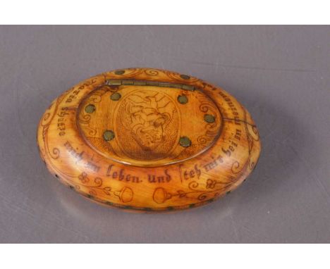 An early  19th Century German horn snuff box, of oval shape and decorated with images of the Virgin and the Vigin and Child a