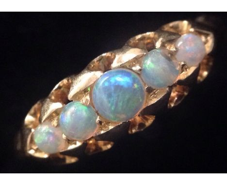 A graduating five stone opal ring, 18ct gold shank, size L, 2.8g gross