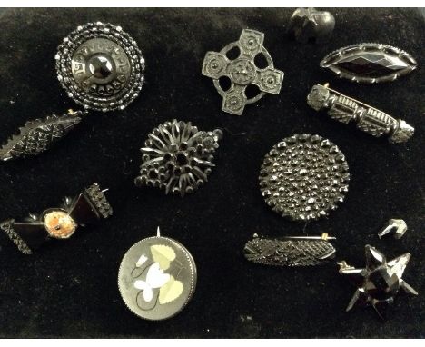 Mourning Jewellery - a Victorian Whitby Jet and agate panel bar brooch;  others as a star, cross, stepped shield, diamond loz