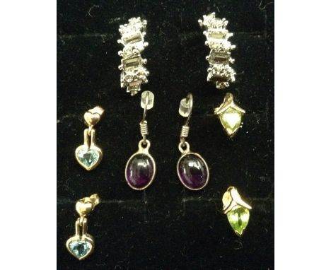 Earrings - a pair of peridot and yellow metal arrow head studs, unmarked;  a pair of blue topaz and yellow metal double heart