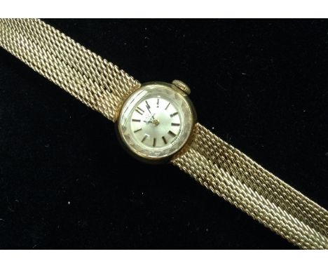 Omega - a 9ct gold lady's wristwatch, round silvered dial, baton markers, manual wind movement, integral 9ct gold chain link 