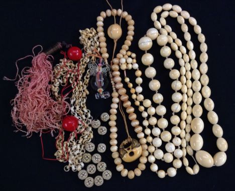 A graduated ivory globular bead necklace;  another similar oval;  a ivory bracelet decorated with flowers;  a Netsuke pendant