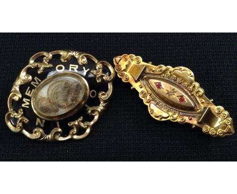 A Victorian black enamelled and and hair work mourning brooch, central oval aperture inset with a hair work and gold thread p