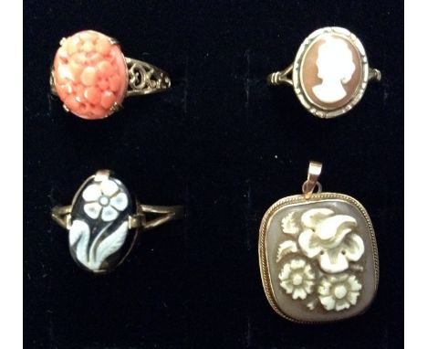 A carved coral ring, the pink oval coral carved as a bunch of flower heads, pierced scrolling shoulders, 9ct gold shank, size