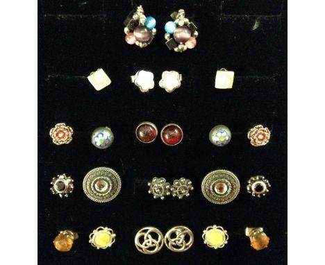 Earrings - a pair of carved mother of pearl flower head studs;  a pair of silver and yellow metal shield boss studs;  a pair 