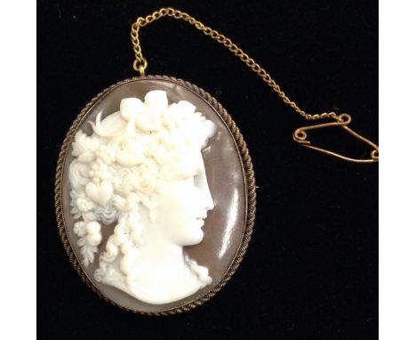 A 19th century shell carved cameo portrait brooch,  flora head and neck facing right, oval silver rope twist frame, stamped s