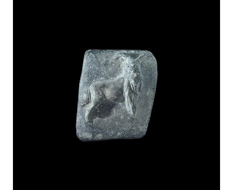 An undated archaistic rectangular ceramic block, in 1st millennium AD style, with high-relief image of a standing ibex facing