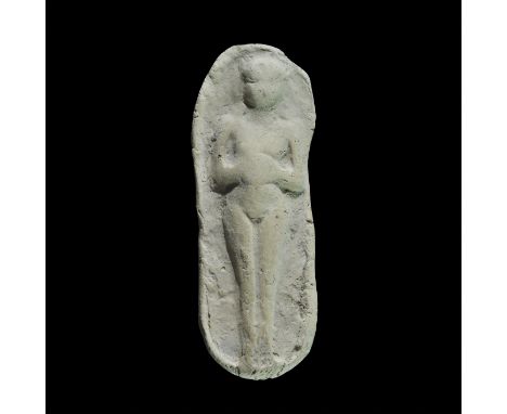 An undated archaistic rectangular ceramic block, in 1st millennium BC style, with high-relief image of a standing nude female