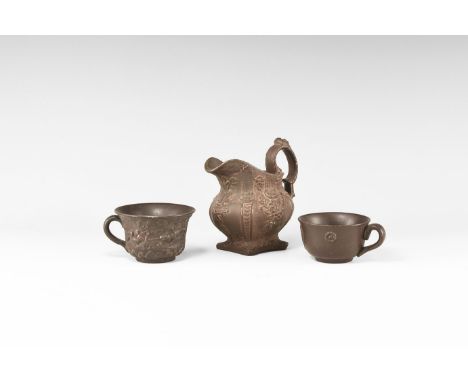 19th century AD. A group of three ceramic vessels comprising of a milk jug with relief floral panels to the sides, arched han