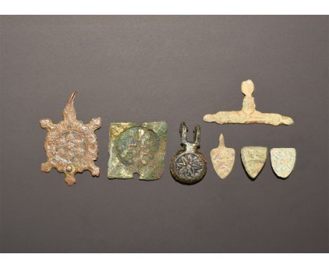 13th-15th century AD. A mixed group of heraldic mounts comprising: a harness pendant with reserved sexfoil on a blue enamel f