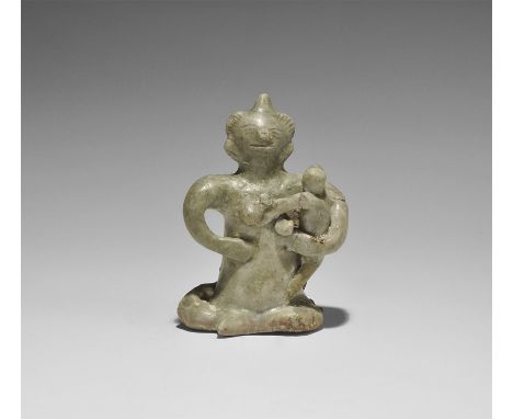 14th-16th century AD. A green-glazed ceramic figurine of a nude seated female suckling a baby.  128 grams, 86mm (3 1/4"). Pri