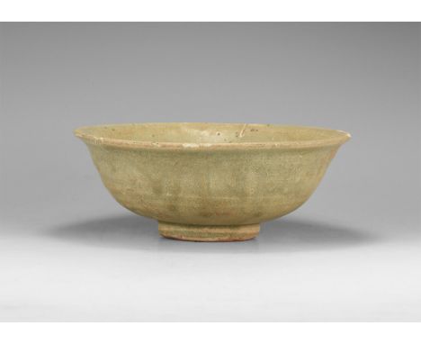Ming Dynasty, 1368-1644 AD. A ceramic bowl with basal ring and flared rim, green glaze.  464 grams, 16.5cm (6 1/2"). Property