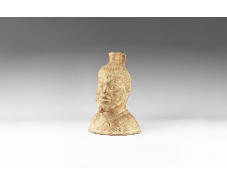An undated archaistic ceramic vase in the form of a Satyr head , small funnel to the top with applied handle to the rear; hai
