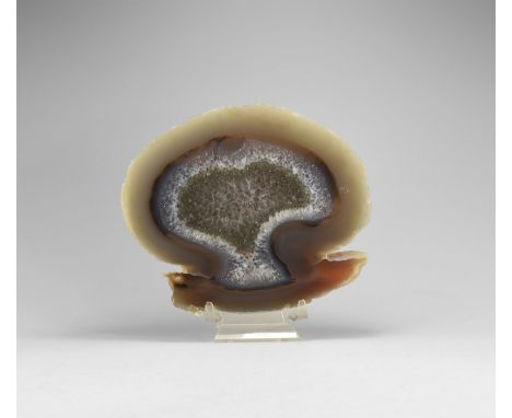 A thick cut and polished brown and blue agate slice with central section of honeycomb crystals.  730 grams, 17.2cm (6 3/4"). 