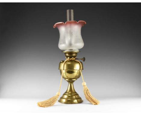 19th century AD. A brass oil lamp with pedestal foot, drum-shaped chamber, burner with adjustment handle, glass chimney and b