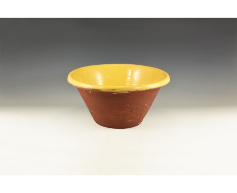 Late 19th-early 20th century AD. A large terracotta planter with turned rim, thick yellow glaze to the inner face.  5.8 kg, 4