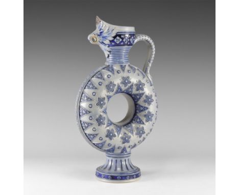 20th century AD. A blue-glazed ceramic jug with annular body, flared base and rim with beaded detailing, scooped mouth with s