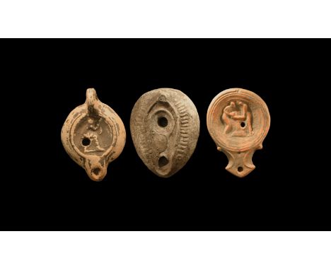 1st-5th century AD. A mixed group of undated archaistic ceramic oil lamps comprising: one slipper-shaped with radiating bille