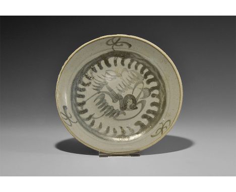 19th century AD. A tin-glazed dish with basal ring; concentric blue lines to the inner face with blue floral and tendril moti