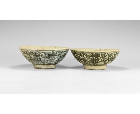 Ming Dynasty, 1368-1644 AD. A matched pair of tin-glazed ceramic bowls each with a basal ring, band of blue foliage to the ou