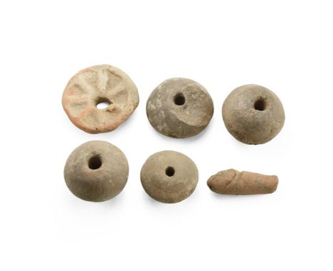 1st-2nd century AD. A mixed group of terracotta items comprising: four biconvex discoid loom weights; a plano-convex loom wei
