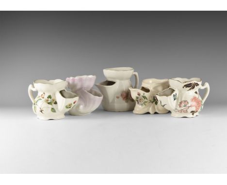 20th century AD. A mixed group of white-glazed ceramic shaving mugs comprising: one with polychrome floral motifs, marked to 