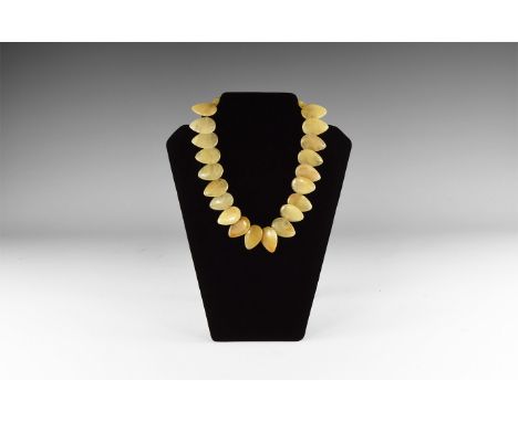 20th century AD. A choker-length necklace of teardrop jade(?) plaques; sprung clasp.  141 grams, 45cm (17 3/4"). Property of 