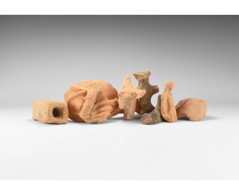 5th-3rd century BC. A mixed ceramic fragment group comprising: two zebu statuettes; the arm of a cloaked figure; a sandalled 